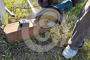 Cutting bricks with an angle grinder, construction work, the process of execution close-up