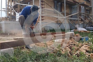 Cutting bricks with an angle grinder in a rural yard