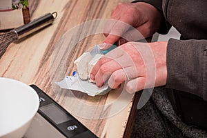 Cutting a cube of yeast with a small knife