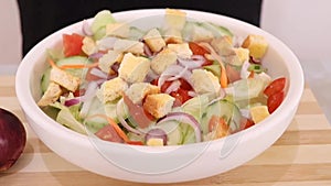 Cutting cucumber, tomato and onion and making salad by mixing apple sider vinegar. Healthy food concept. Cutting vegetable and