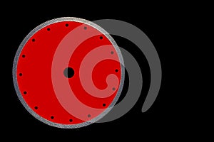 Cutting disc for precise cutting of the granite red color with diamond diameter of 230 mm isolated on the black background