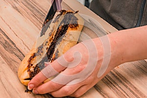 Cutting the dough of chocolate cake