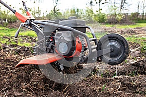 Cutting-edge agricultural technology at play: the tiller meticulously tills the untouched soil, setting the stage for