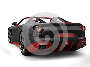 Cutting edge sports car - matte black with fiery red details - back view
