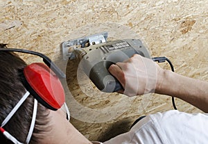 Cutting with electric handsaw photo
