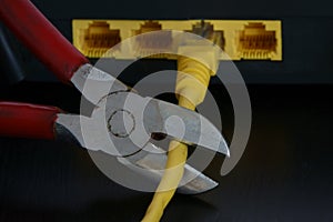 Cutting an Ethernet Cable Connected to an Internet Modem With a Wire Cutter