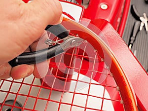 Cutting the excess of string of a Tennis racquet photo