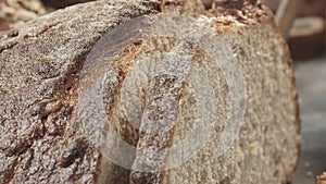 Cutting of fresh baked Dutch wheat bread close-up.