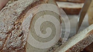 Cutting of fresh baked Dutch wheat bread close-up.