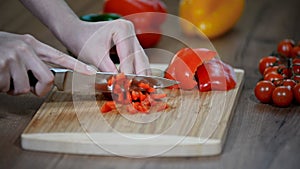 Cutting fresh red pepper. Fresh pepper on a wooden board. Cook cut vegetables with a knife.