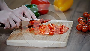 Cutting fresh red pepper. Fresh pepper on a wooden board. Cook cut vegetables with a knife.