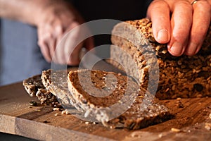 Cutting fresh whole wheat bread into slices