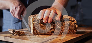 Cutting fresh whole wheat bread into slices