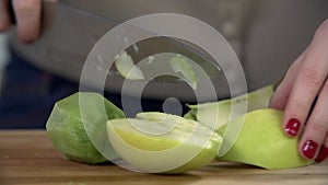 Cutting green apple in slow motion