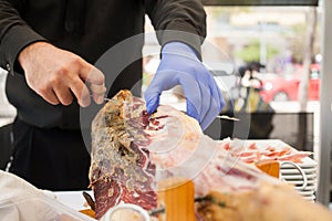 Cutting ham with gloves