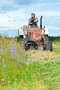 Cutting hay on tractor