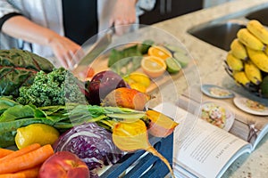 Cutting healthy fruits and vegetables for a recipe photo