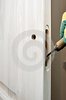 Cutting a hole for a door lock with a carpenter chisel