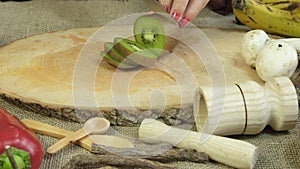 Cutting Kiwi Slices With Knife