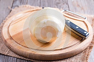 Cutting a kohlrabi on a wooden table