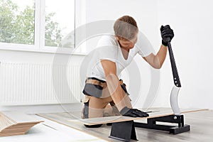 Cutting laminate with a manual cutter.