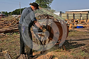 Cutting logs into firewood on a steam powered saw