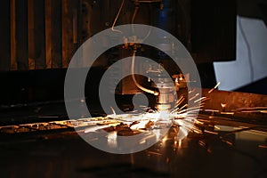 Cutting machine in work and metal plate, sparks fly of machine head