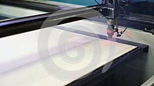 Cutting machines with laser and drill operate with plank