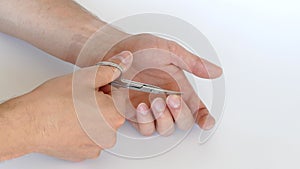Cutting male nails with manicure scissors. High quality 4k footage