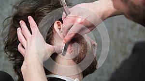 cutting man's beard with the straight razor