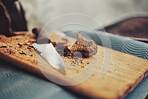 Cutting mapacho tobacco on a board.