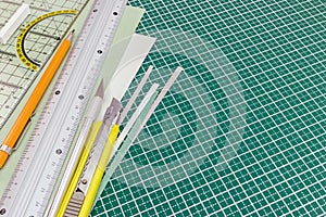 Cutting mat with utility knife, mechanical pencil, metal ruler a