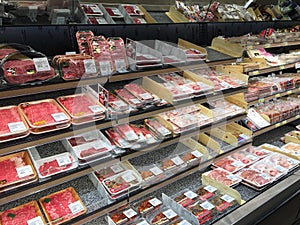 Cutting meat in refrigerator for sale at store USA