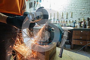 Cutting metal with an angle grinder. Metal particles flying