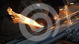 Cutting a metal pipe with a splash of spark.