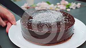 Cutting a moist chocolate cake with a knife