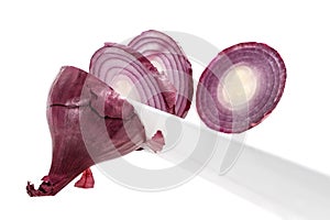 Cutting onions with knife, closeup on white background