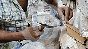 Cutting out mosaic pieces for the traditional Moroccan zellige tile artworks.