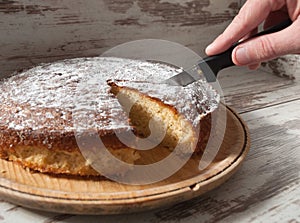 Cutting a piece of sponge cake