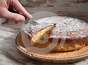 Cutting a piece of sponge cake