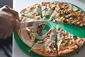 Cutting pizza into slices with knife.