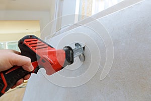 Cutting plasterboard of drywall hand with grunge dirty saw