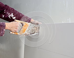 Cutting plasterboard plaster hand dirty saw photo