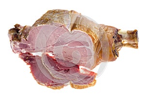 Cutting pork gammon on a bone on white