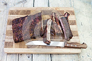 Cutting pork ribs on cutting board