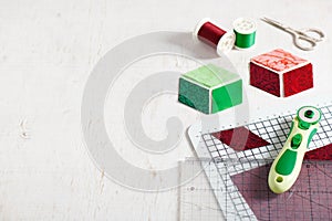 Cutting and preparing diamonds for sewing a quilt in Christmas colors, quilting accessories