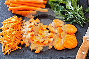 Cutting raw carrots on slice prepare for cooking