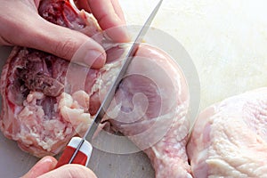 Cutting raw chicken legs