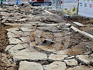 cutting the road surface with a demolition hammer. the hammer crushes