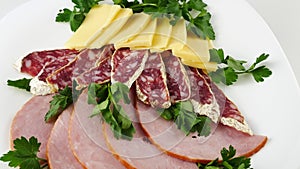 The cutting of sausage and cheese.Pork ham slices.Decorated with parsley.